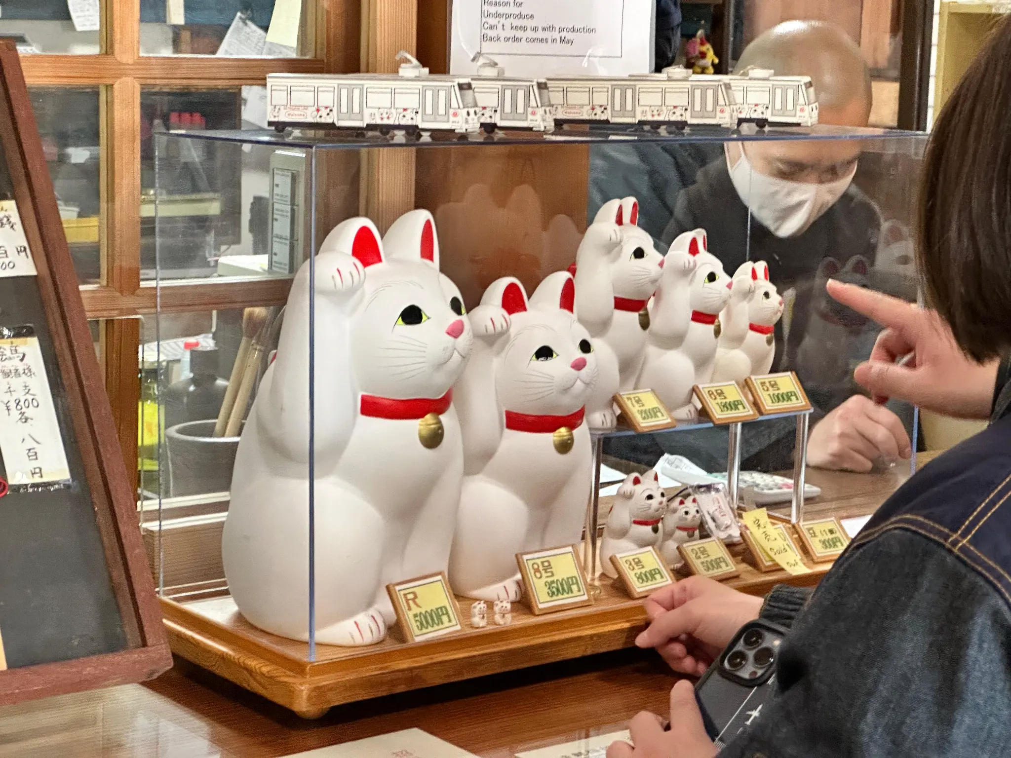 Maneki-neko statues for sale at the Gotokuji Temple shop