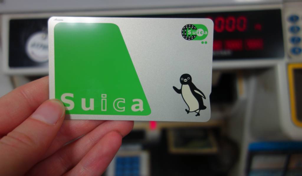 A physical Suica IC card with the penguin mascot
