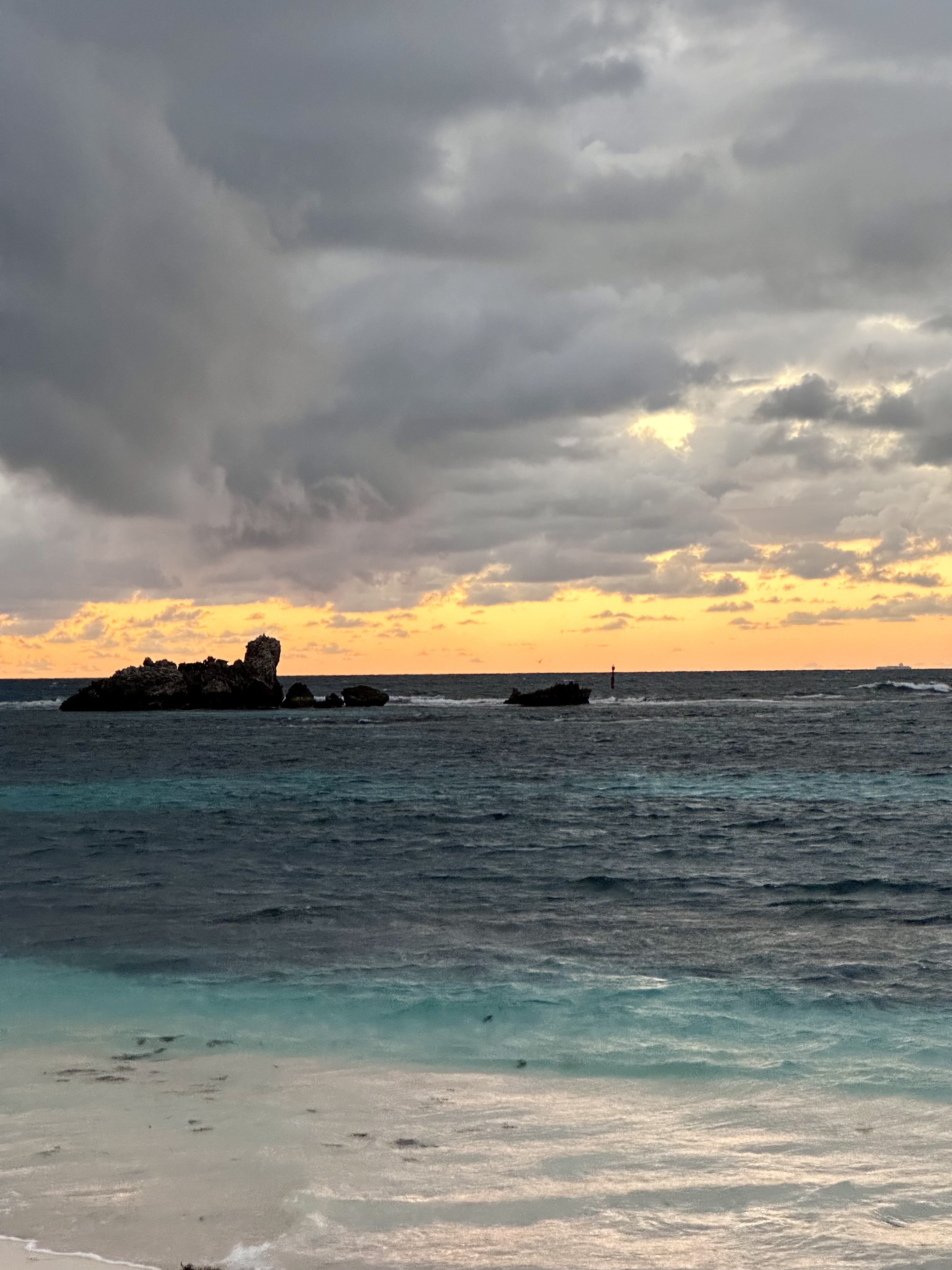 A beautiful sunset over the ocean at Rottnest Island with dramatic clouds